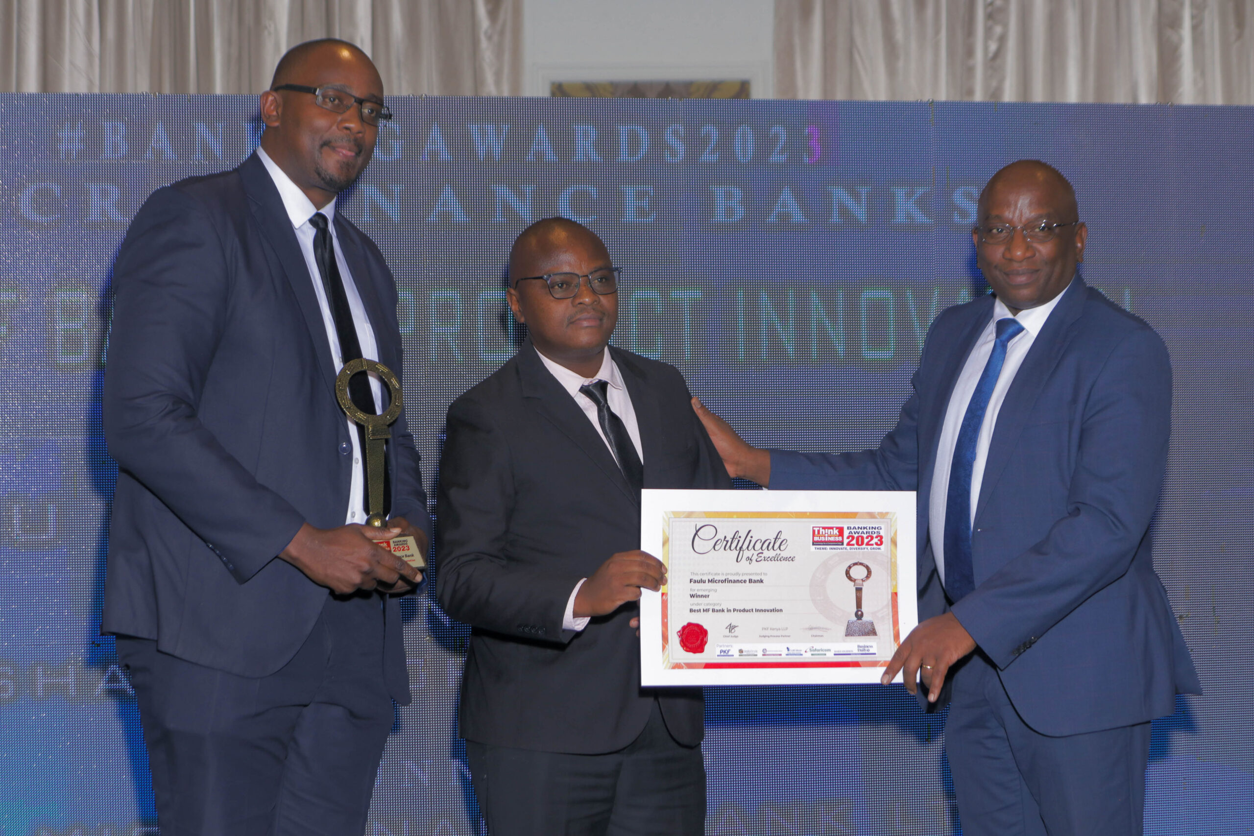 Faulu Bank, Senior Manager, Institutional Banking, Nicholas Akumu, and Product Development Manager Stephen Njuguna receive the 2023 Think Business Award for Best Microfinance Bank in Digital Banking from one of the awards Judges. The Bank was awarded for its unwavering commitment to leveraging technology and innovation to provide accessible and convenient financial solutions to customers.