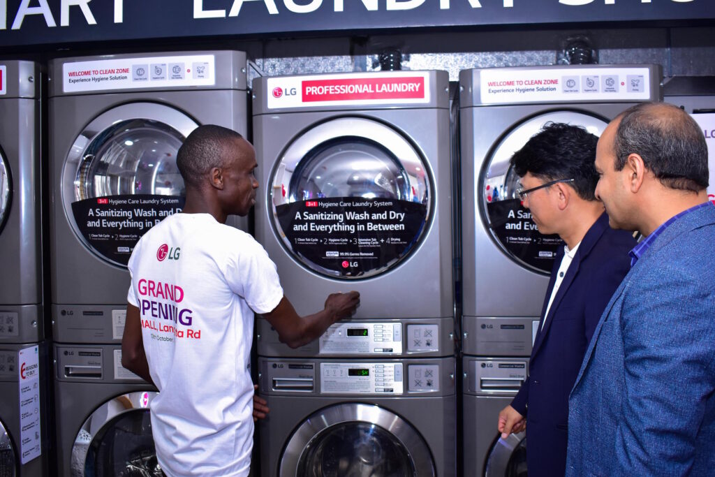 LG Electronics Smart Laundromat reference site laundry attendant Matthew Omuruon, LG Electronics Home Appliance (HA) Product Manager Junho Seo and Opalnet Managing Director Rakesh Singh during the launch of LG’s first Smart Laundromat reference site at the T-Mall shopping mall in Langata, Nairobi. The LG Smart Laundromat reference site will act as a reference for investors seeking to venture into the laundromat business.