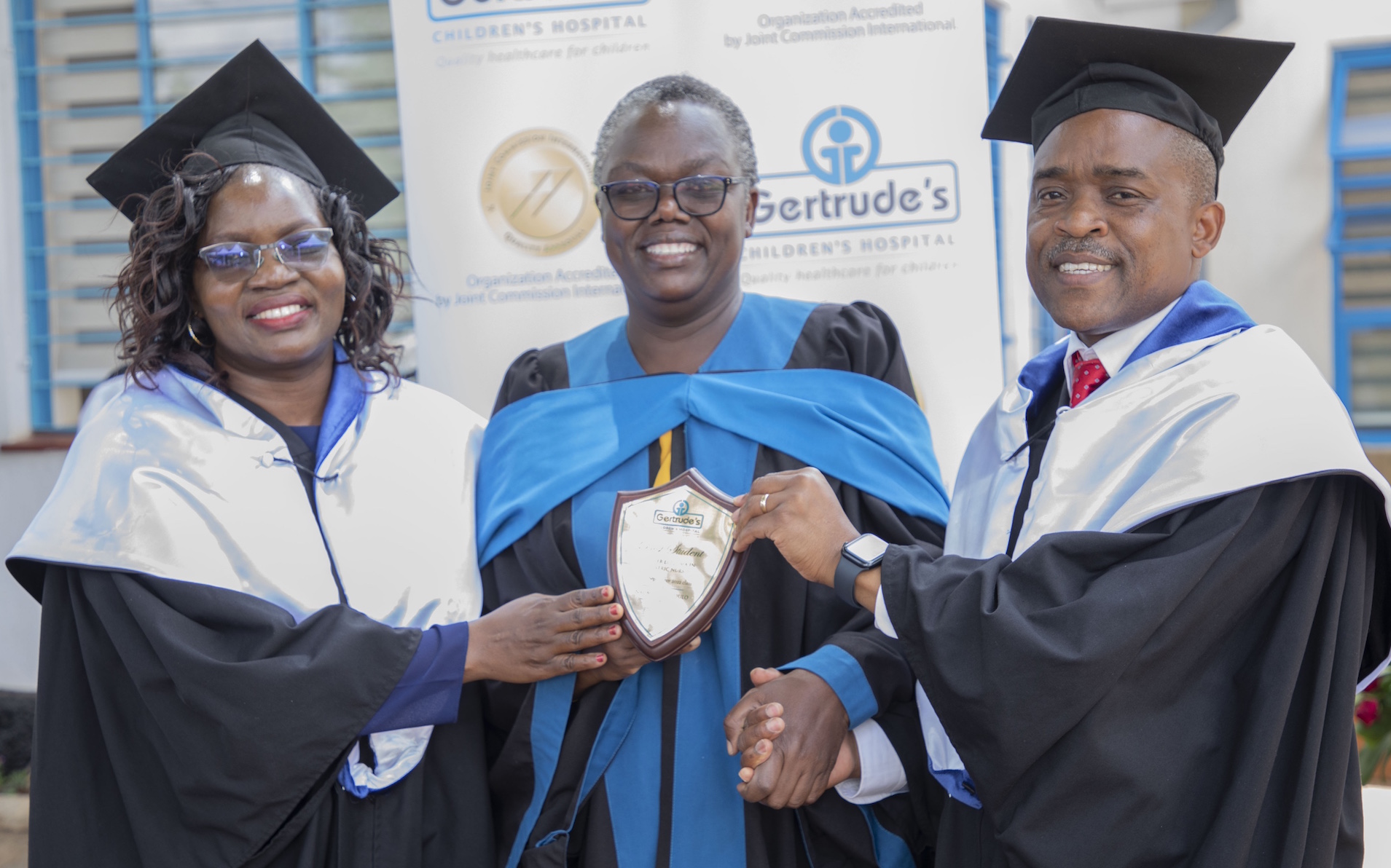 Gertrude's CEO, Dr Robert Nyarango (right), presents the best student award in Higher National Diploma in Kenya Registered Paediatric Critical Care Nursing to Dulo Naomi Akinyi, September 2022 class. Looking on is Gertrude’s Institute of Child Health and Research Principal Perez Obonyo.