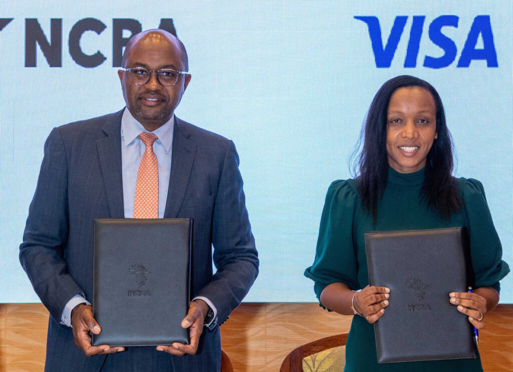 Tirus Mwithiga Group Director Retail Banking NCBA, (left)and Eva Ngigi-Sarwari Ag General Manager Visa East Africa exchange signed MoU during the the launch of Visa Spend Clarity for Enterprise for commercial card clients of NCBA 