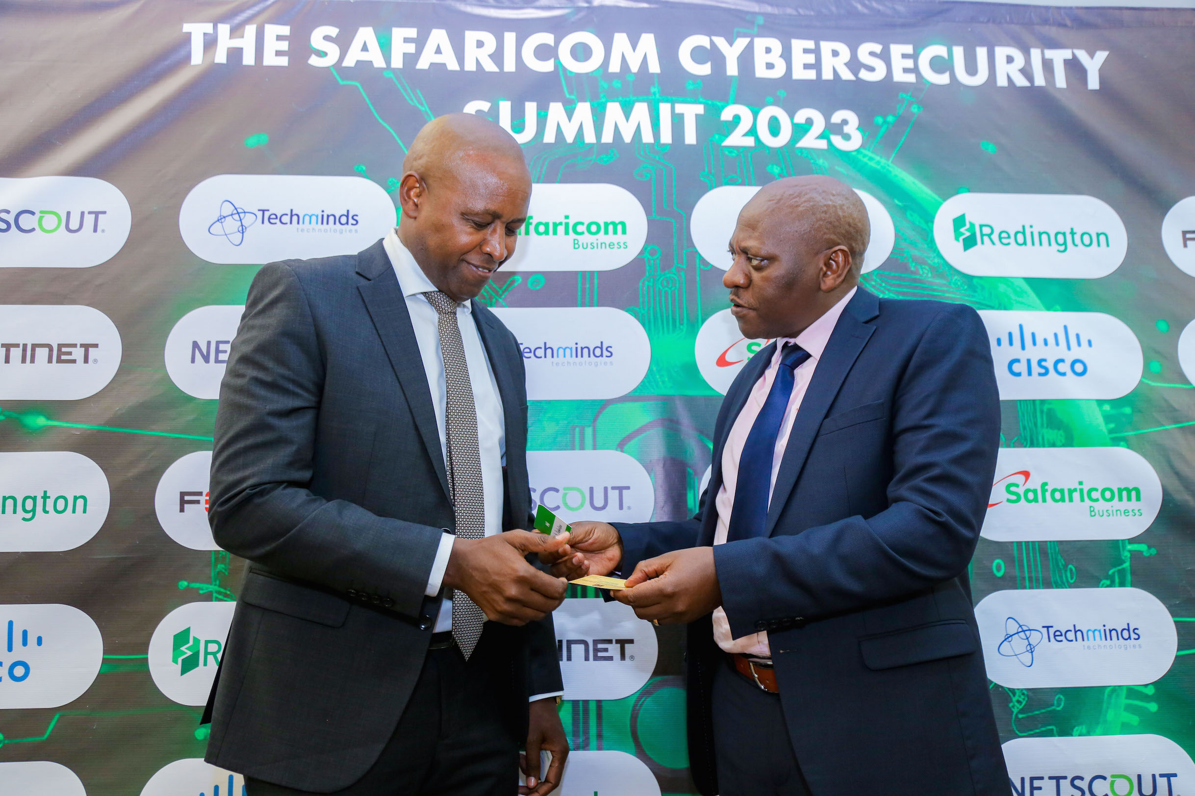 Patrick Kilemi (Left) , Principal Secretary State Department of Co-operatives, consults with Nicholas Mulila , Chief Corporate Security Officer at Safaricom PLC during the CyberSecurity Summit held at a Nairobi Hotel