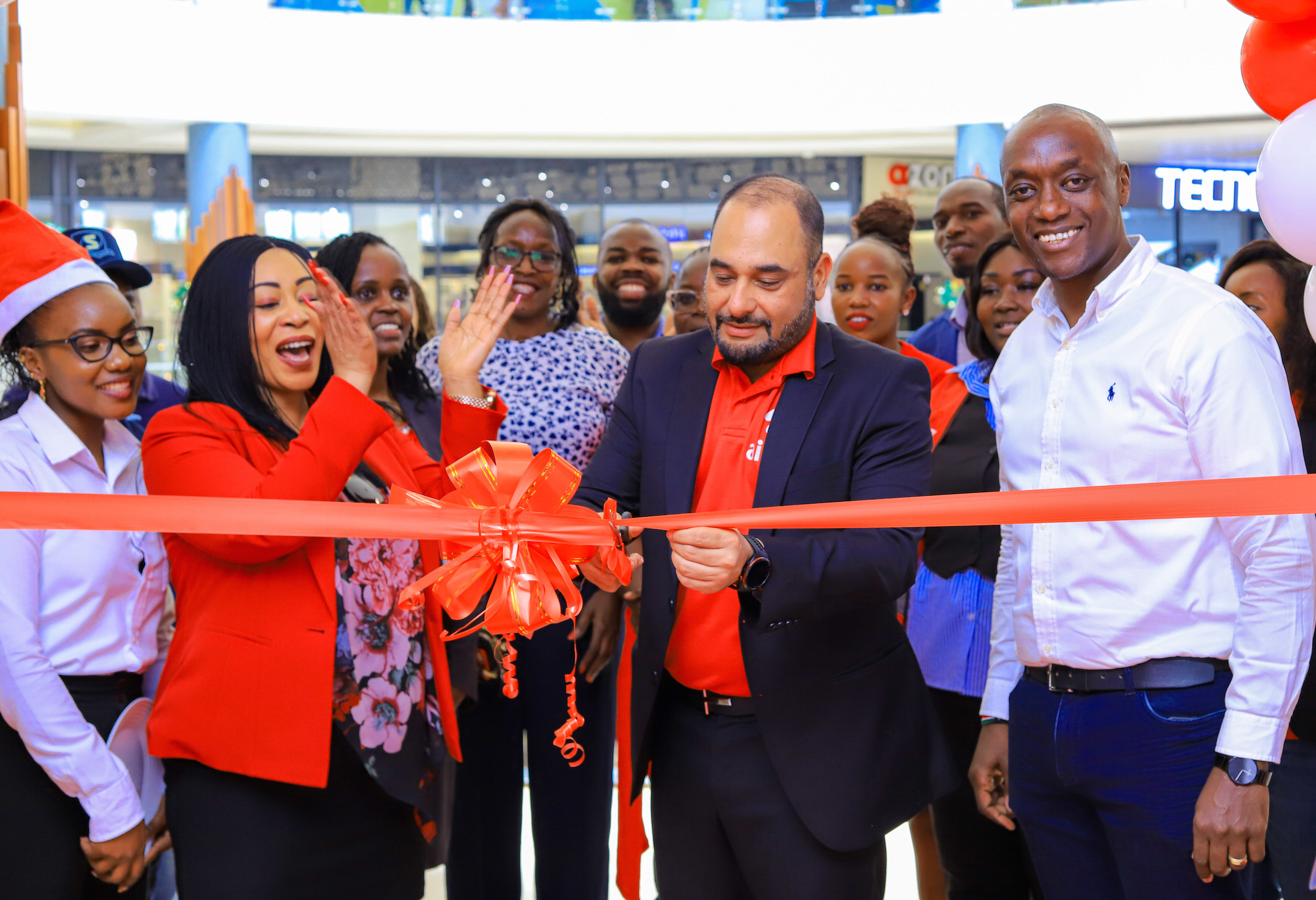 Airtel Kenya MD, Ashish Malhotra cuts the ribbon as he officially opened the Airtel Customer Care shop in Meru.