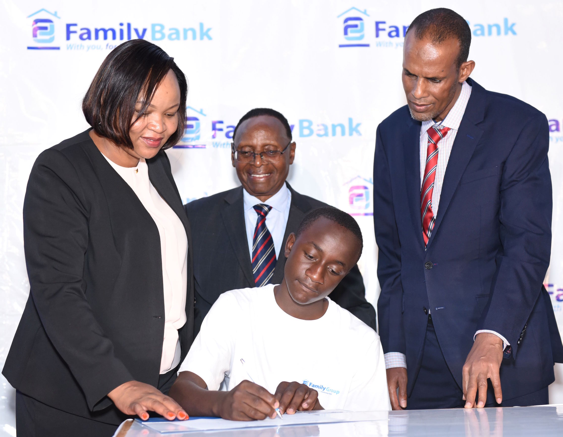 Family Bank CEO Designate Nancy Njau, Chairman Dr. Wilfred Kiboro & Ministry of Education Director General Elyas Abdi with Miguel Zabaro one of the 352 beneficiaries during the 2024 commissioning of the KES. 90 million High School Scholarship Programme.