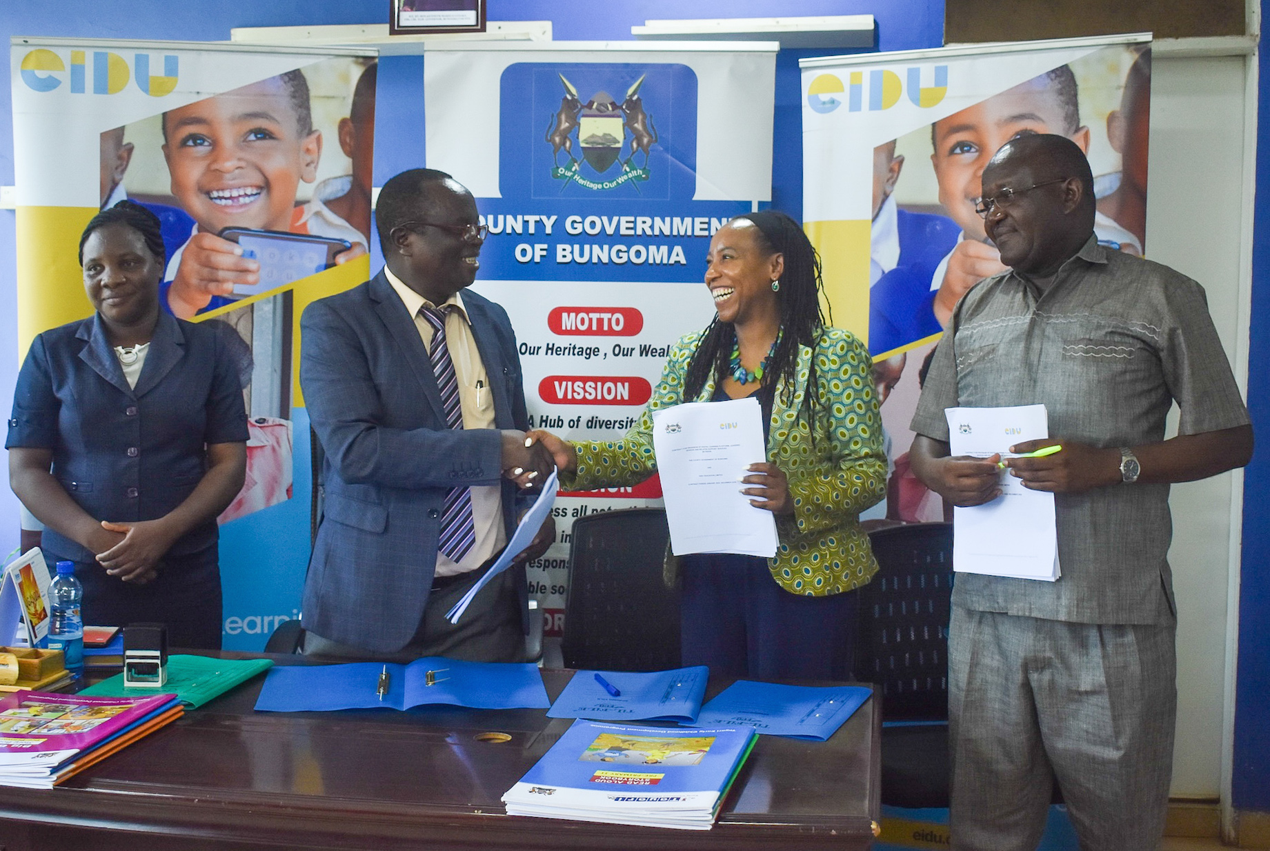 Dr. David Wanyonyi Bungoma CECM for Education and Vocational Training (second left) and EIDU Head of Government Relations, Salome Mwaura (second right) sign a contract to begin the implementation of EIDU’s digital learning program targeting over 3,000 learners from 36 Early Childhood Development and Education (ECDE) centres across the county. They are flanked by Abigael Walaka, Legal Officer- County Attorney office (left) and Nicholas Misoi, Chief Officer-Education. Over 230,000 learners from seven counties across Kenya are already using the program.