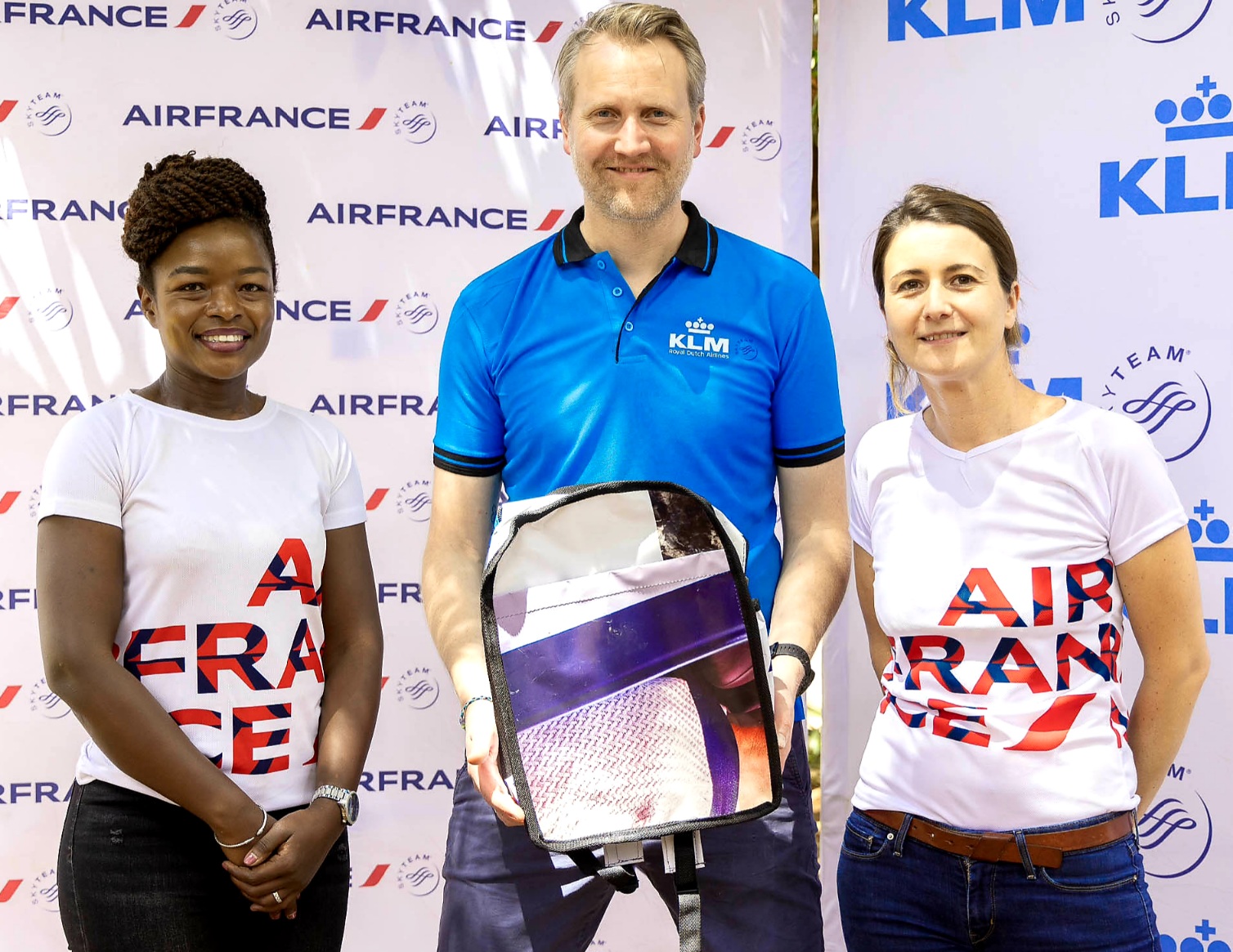 Centre, Air France – KLM Regional General Manager for East and Southern Africa, Marius van der Ham, poses for a photo holding one of the eco-friendly bags made from repurposed billboards and banners with Hildabeta Amiani, Air France - KLM Country Sales Manager for Kenya & Offline Markets (left) and Stephanie Spelle, Air France – KLM Regional Commercial Director for East and Southern Africa (right) after a successful donation of the said bags to Muthangari Primary School.