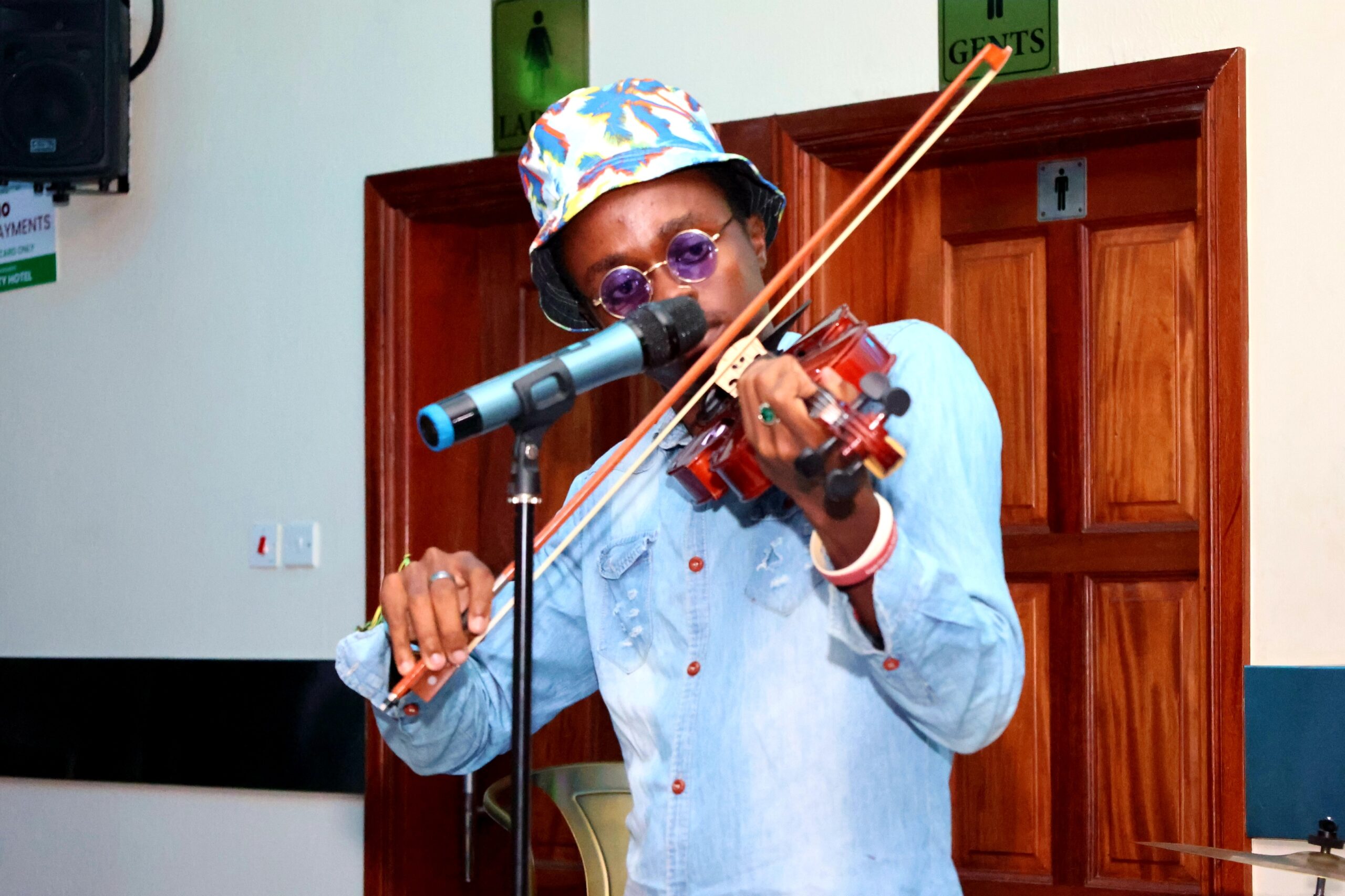 Mutuku Junior plays the violin at EAJAK Talent Tuesdays. PHOTO/COURTESY